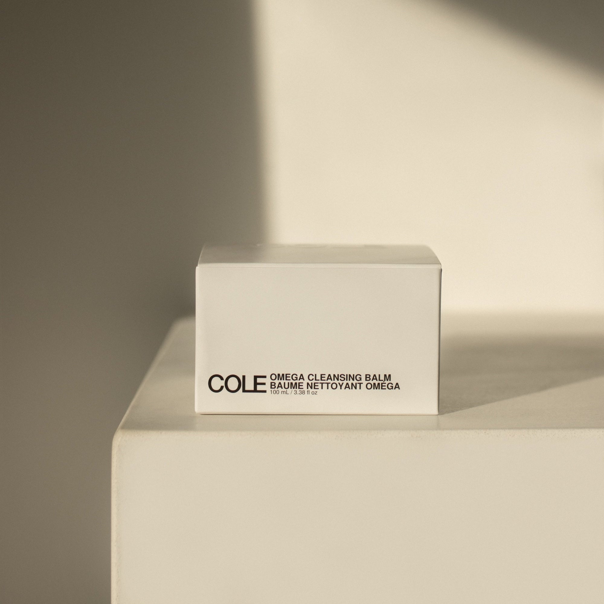 Box of COLE Omega Cleansing Balm on a neutral background