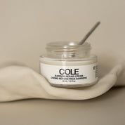 Jar of COLE Barber Repair Cream on a beige background