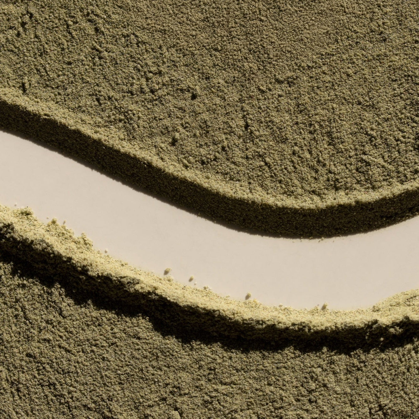 Close-up of a textured green surface with wavy patterns